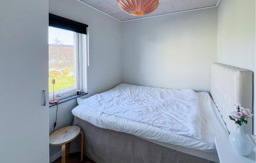 a small bedroom with a bed and a window at 3 Bedroom Cozy Home In Grebbestad in Grebbestad