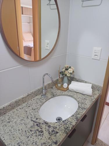 a bathroom counter with a sink and a mirror at Village Baixio in Baixio