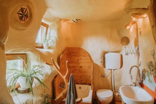 a bathroom with a toilet and a sink at Private Eco Cottage in Nature in Šulinci