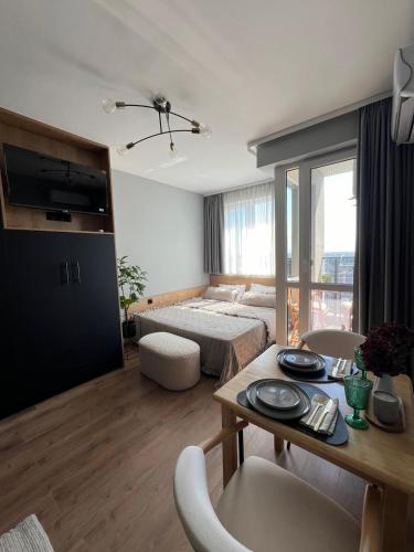 a room with a bed and a table with chairs at Studio79 in Plovdiv