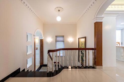 a hallway with a spiral staircase in a home at Villa La Rose Blanc Thảo Điền in Ho Chi Minh City
