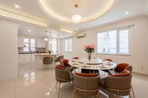 a kitchen and dining room with a table and chairs at Villa La Rose Blanc Thảo Điền in Ho Chi Minh City