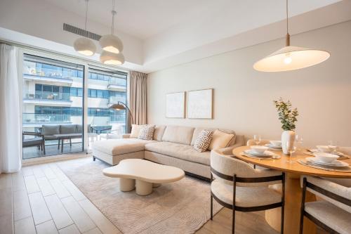 a living room with a couch and a table at Sustainable Stylish Mayan 1 Bedroom - Yas Island 809 Mayan 4 in Abu Dhabi