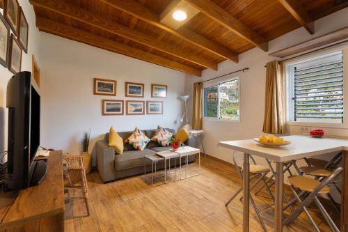 a living room with a couch and a table at Casa Carlos - Vista Mar in Hermigua