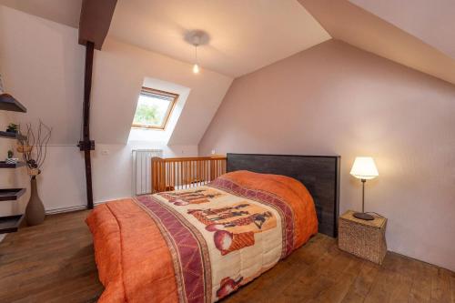 a bedroom with a large bed in a attic at Maison confortable près de la Forêt de Brocéliande, BBQ in La Chapelle-Caro