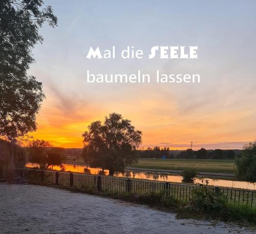 a sunset over a river with the words mal dieekleonneiane lessel at SUNBI-Chalet in Lathum