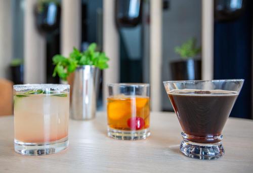 three different types of drinks sitting on a table at voco Flagstaff by IHG in Flagstaff