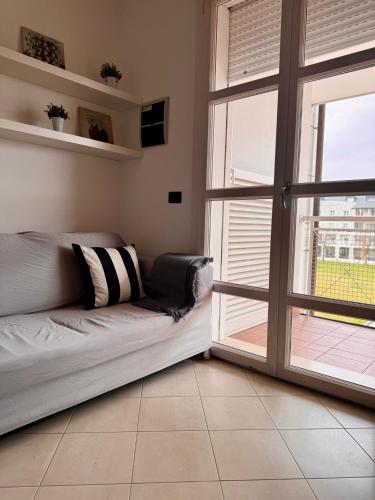 a living room with a couch and an open door at Boutique Home in Castelfranco Veneto