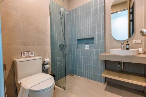 a bathroom with a toilet and a sink and a mirror at Sea Side at Ao Nang Landmark Night Market Krabi in Ban Khlong Haeng