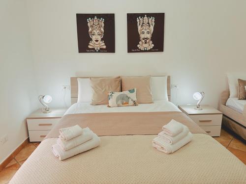 a bedroom with a large bed with towels on it at Sicania - In centro Storico a Palermo in Palermo