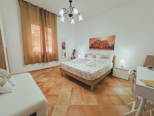 a bedroom with a bed and a table in it at Sicania - In centro Storico a Palermo in Palermo