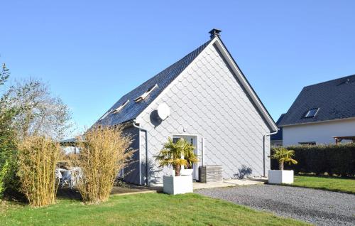 a white church with a black roof at Beautiful Home In Auberville With Wifi in Auberville