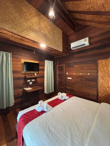 En eller flere senge i et værelse på Boutique Village Hotel