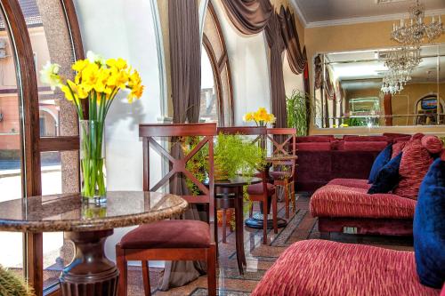 a living room with a vase of yellow flowers on a table at Optima Collection Kamianets-Podilskyi in Kamianets-Podilskyi