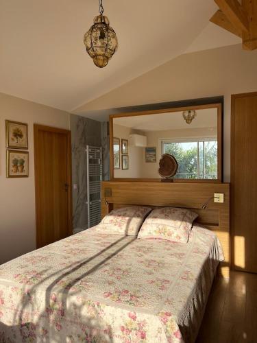 a bedroom with a large bed with a large mirror at Saint Clair, la plage à pied in Le Lavandou