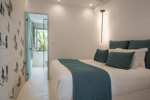 a bedroom with a bed with green and white pillows at Hotel Senia - Onar Hotels Collection in Naousa