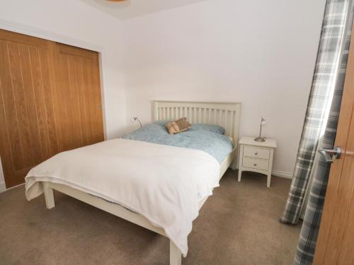 a bedroom with a bed and a wooden door at The Old House, Balure in Oban