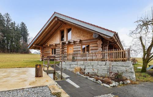 a log cabin with a stone wall in front of it at Blockhaus Chalet in Waffenbrunn