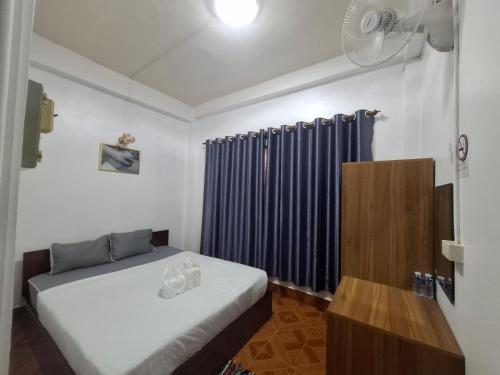 a room with two beds and a fan in it at vangvieng SCK Hotel in Vang Vieng