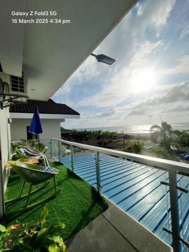 a balcony with a view of a swimming pool at The beach house, Baroro in Bacnotan