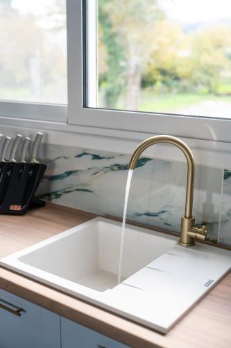 a kitchen sink with water coming out of it at The Greek Getaway in Lóngos