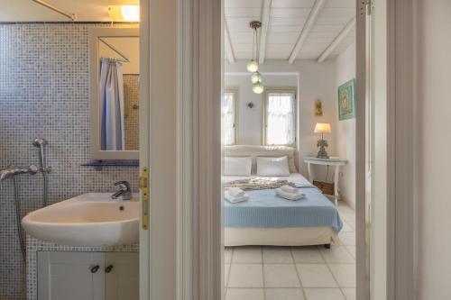 een slaapkamer met een bed, een bad en een wastafel bij Coral Pearl in Isterni