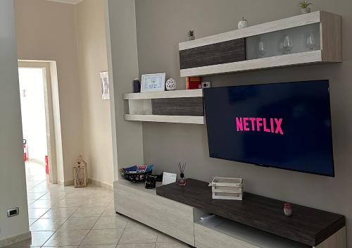 a living room with a television on a wall at Casa Zio Nicola - Appartamento in Centro ad Andria in Andria