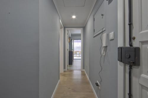 a hallway with a phone on the wall at Jamor Terrace by Homing in Cruz Quebrada