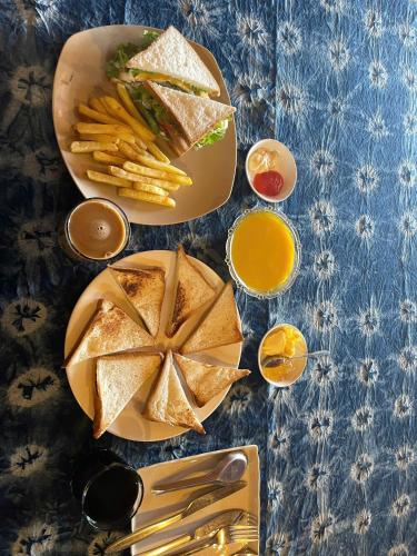 a table topped with a sandwich and french fries at Hmong Farmstay in Sa Pa