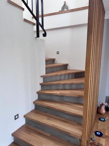 a staircase in a home with wooden floors at Villa Kataraktis in Seferihisar