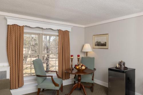 a room with a table and chairs and a window at Brandywine River Hotel in Chadds Ford