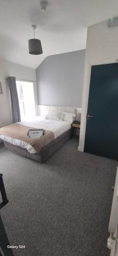 a bedroom with a bed and a door in it at 'James Lyons' The old main St in Ballyhaunis