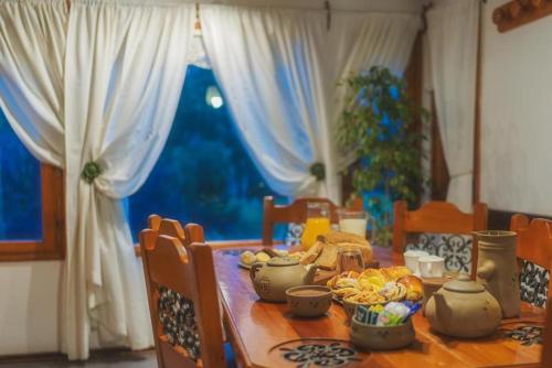 a dining room table with food on top of it at Apart Presidencial ROTUI in San Martín de los Andes