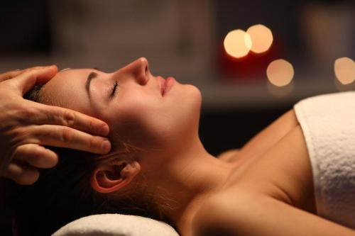 a woman laying on a towel with her hand on her face at Domaine de la Blonnerie in Feings