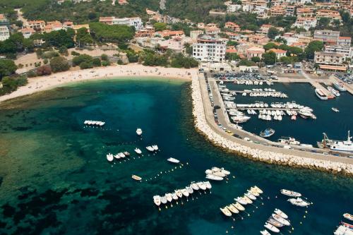 an aerial view of a harbor with boats in the water at BUE MARINO Hotel & Roof Lounge in Cala Gonone