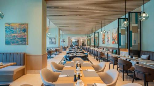 a dining room with tables and chairs at Radisson Hotel Istanbul Merter in Istanbul