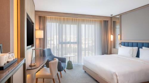 a hotel room with a bed and a large window at Radisson Hotel Istanbul Merter in Istanbul