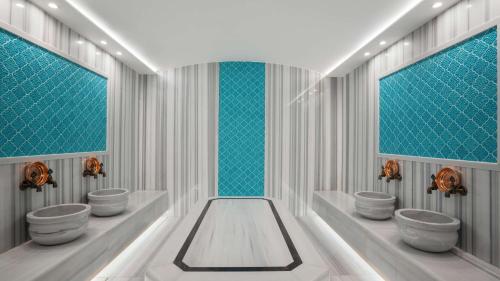 a bathroom with four sinks and a row of windows at Radisson Hotel Istanbul Merter in Istanbul