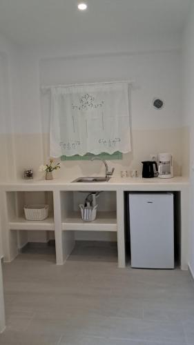 a white desk in a room with a counter at Arkesini Apartments in Arkesíni