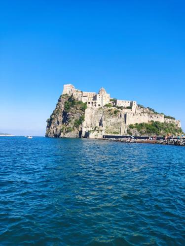 a castle on an island in the water at Ischia Dream Loft da Nancy in Ischia