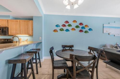a kitchen with a table and chairs in a room at Crystal Tower 1906 by Vacation Homes Collection in Gulf Shores