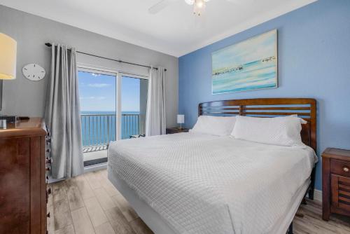 a bedroom with a bed with a view of the ocean at Crystal Tower 1906 by Vacation Homes Collection in Gulf Shores