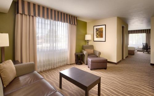 a hotel living room with a couch and a table at Holiday Inn Express & Suites American Fork - North Provo by IHG in American Fork