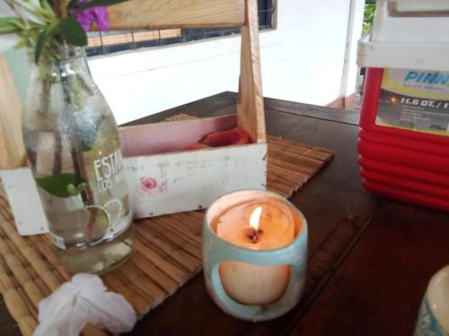 a candle sitting on a table next to a box at Hotel La Laurina Casa de Campo in Garupá