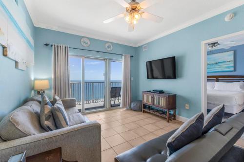 a living room with a couch and a tv at Crystal Tower 1906 by Vacation Homes Collection in Gulf Shores