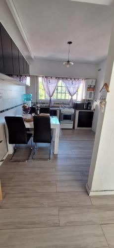 a kitchen with a table and chairs in a room at Ohana in Lomas del Mirador