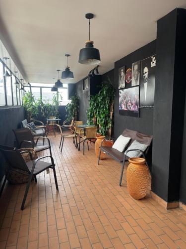 a restaurant with chairs and tables and plants at Hotel WLH Silver Corferias in Bogotá