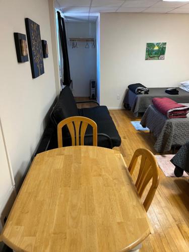a living room with a wooden table and a couch at Art Gallery Hostel in Whitefield