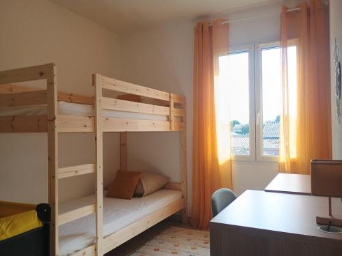 une chambre avec deux lits superposés et un bureau dans l'établissement Villa Beau Soleil Piscine Jardin Parking, à LʼIsle-sur-la-Sorgue