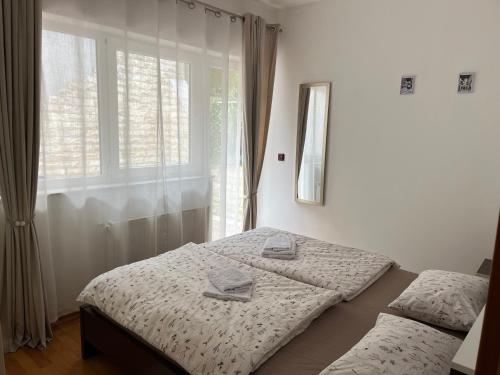 a bedroom with two beds and a window at De lux Do in Zagreb